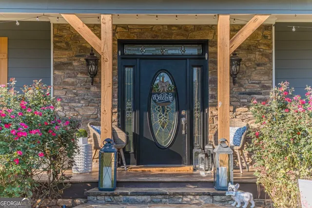 a kitchen with stainless steel appliances a sink a stove a refrigerator cabinets and a window