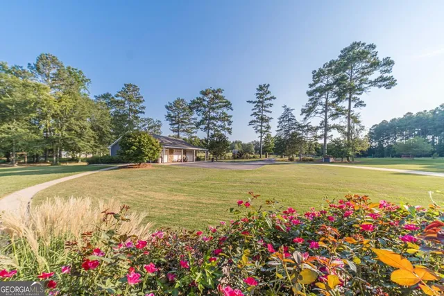 a kitchen with granite countertop white cabinets stainless steel appliances and a window