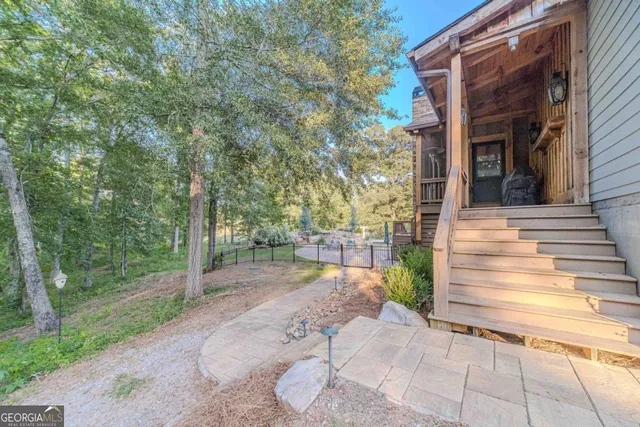 a view of a dining room and livingroom with furniture wooden floor a chandelier