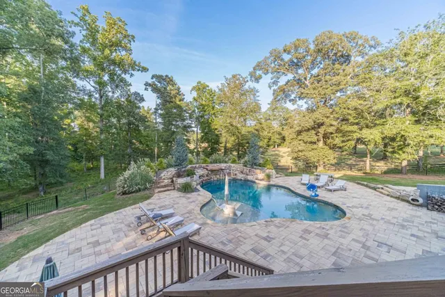 a living room with furniture a window and a flat screen tv