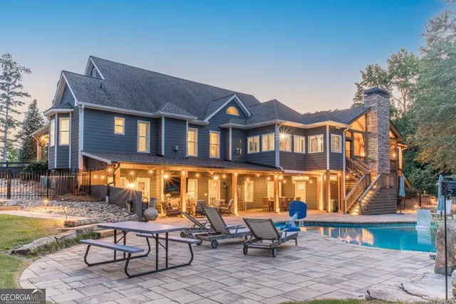 a bathroom with a granite countertop toilet a sink a mirror and a shower curtain