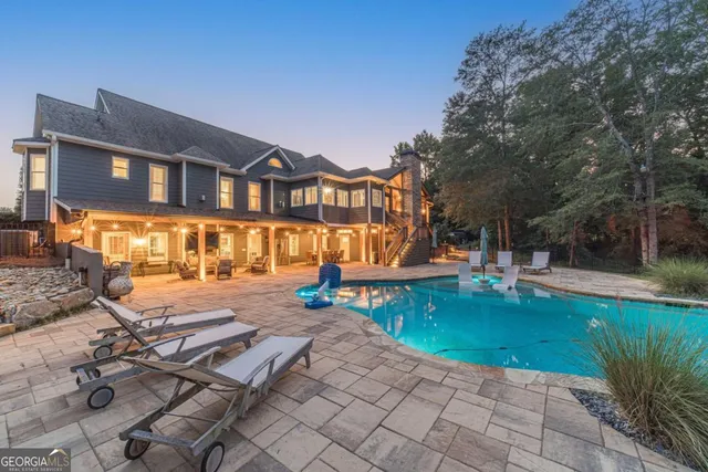 a bathroom with a granite countertop sink a mirror and a bathtub