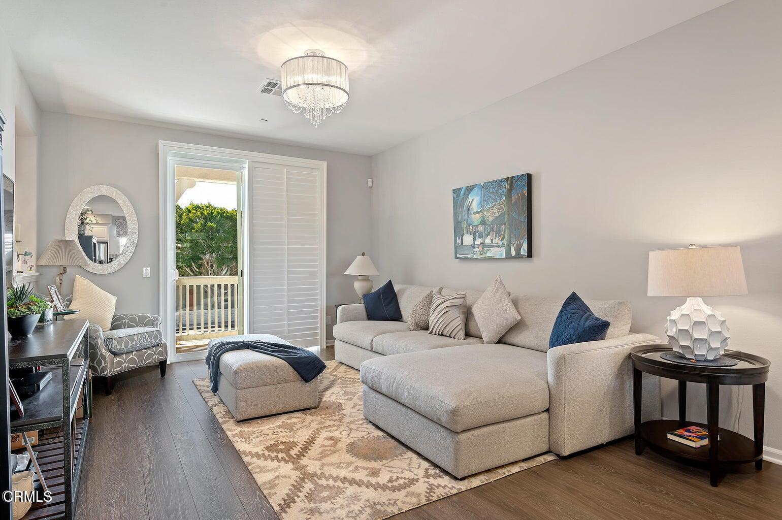 3661 West Hemlock Street Oxnard, CA 93035 - Photo 11 of 21 a living room with furniture a lamp and a window