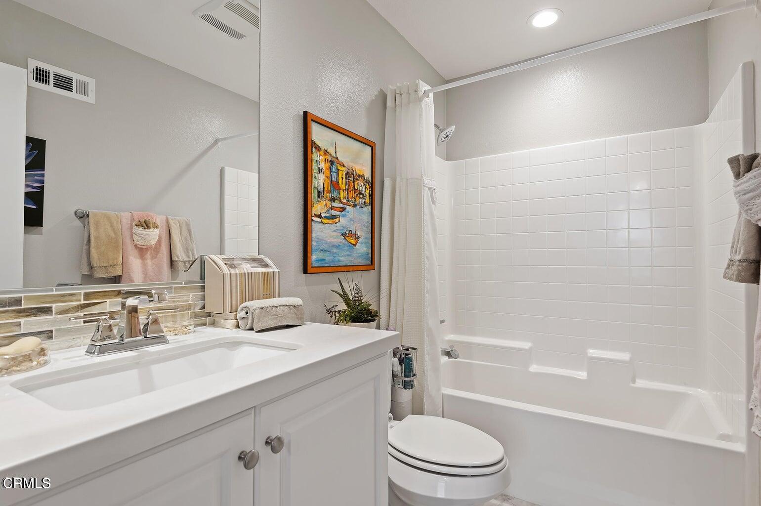 3661 West Hemlock Street Oxnard, CA 93035 - Photo 13 of 21 a bathroom with a sink a toilet and shower