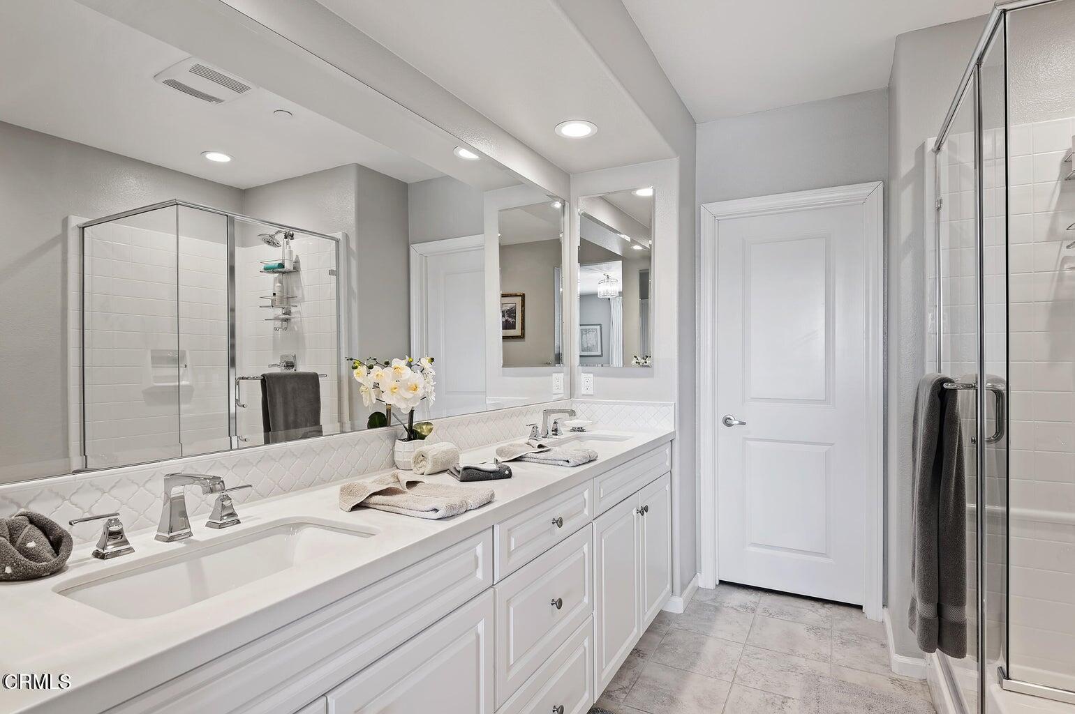 3661 West Hemlock Street Oxnard, CA 93035 - Photo 18 of 21 a bathroom with double vanity sinks and a mirror