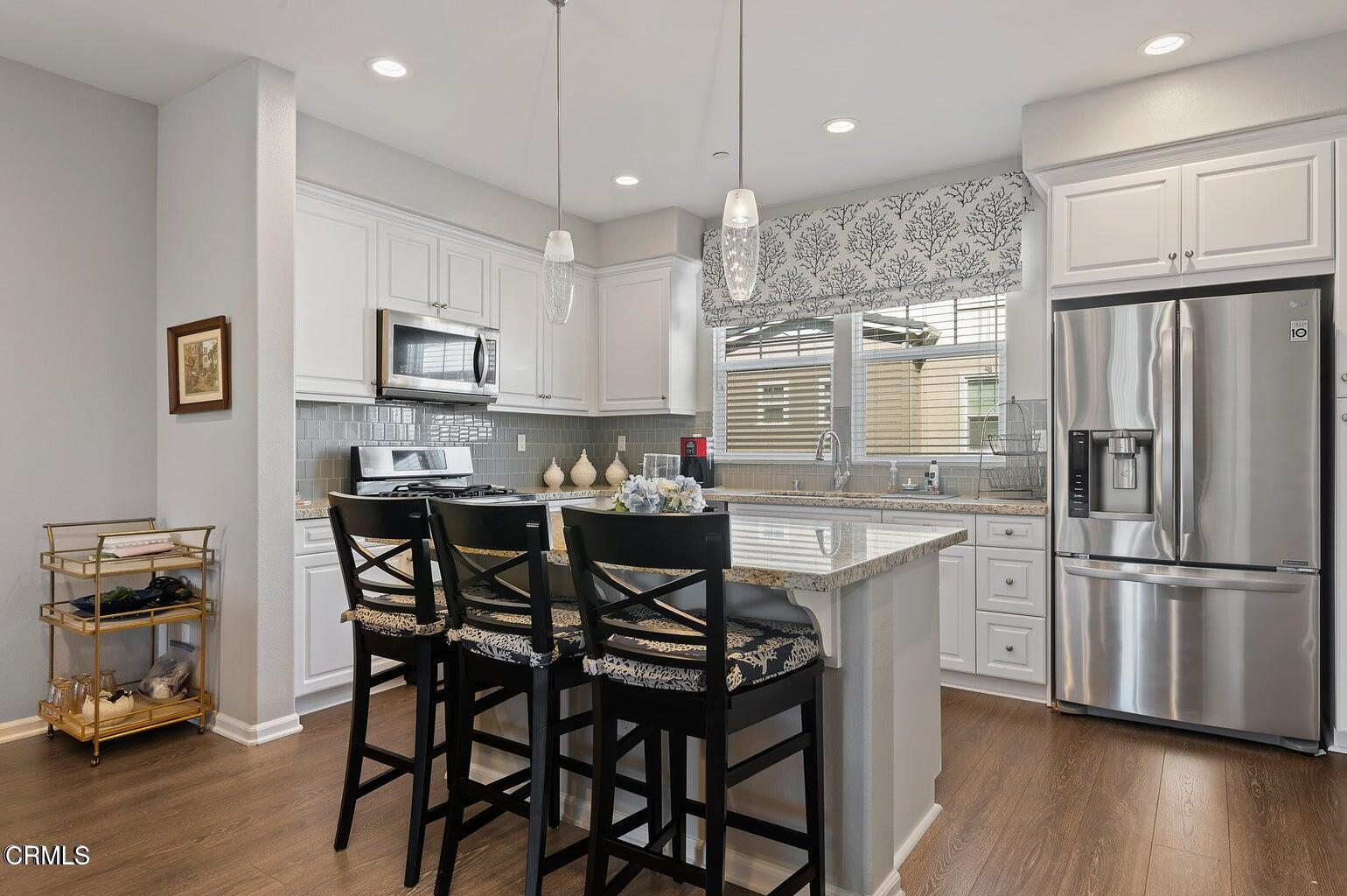 3661 West Hemlock Street Oxnard, CA 93035 - Photo 8 of 21 a kitchen with kitchen island appliances cabinets and furniture