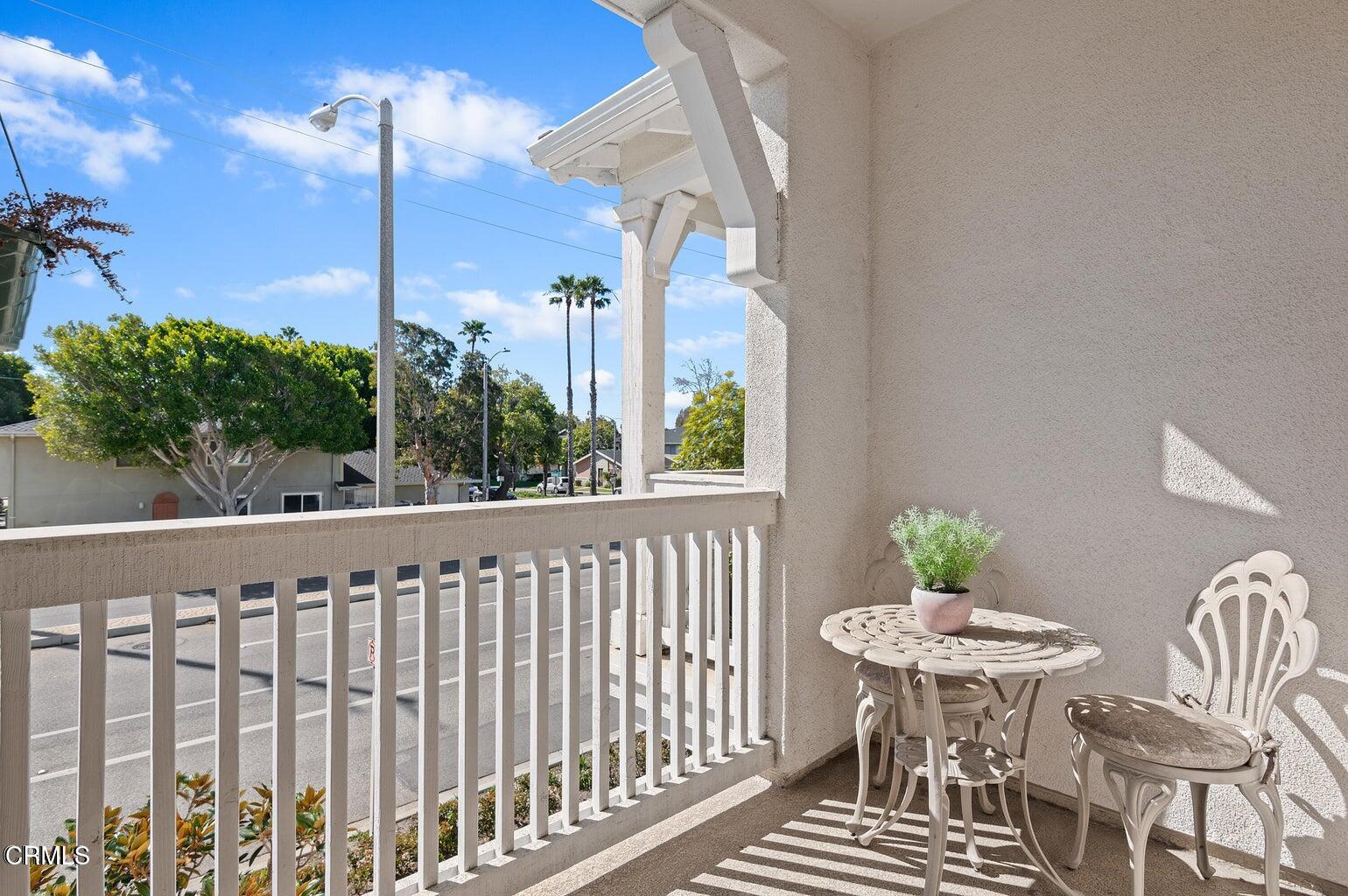 3661 West Hemlock Street Oxnard, CA 93035 - Photo 9 of 21 a view of a balcony with table and chairs