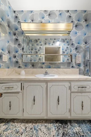 a close view of granite countertop white cabinets