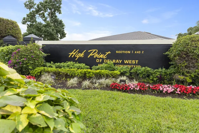 a view of sign board with flower around