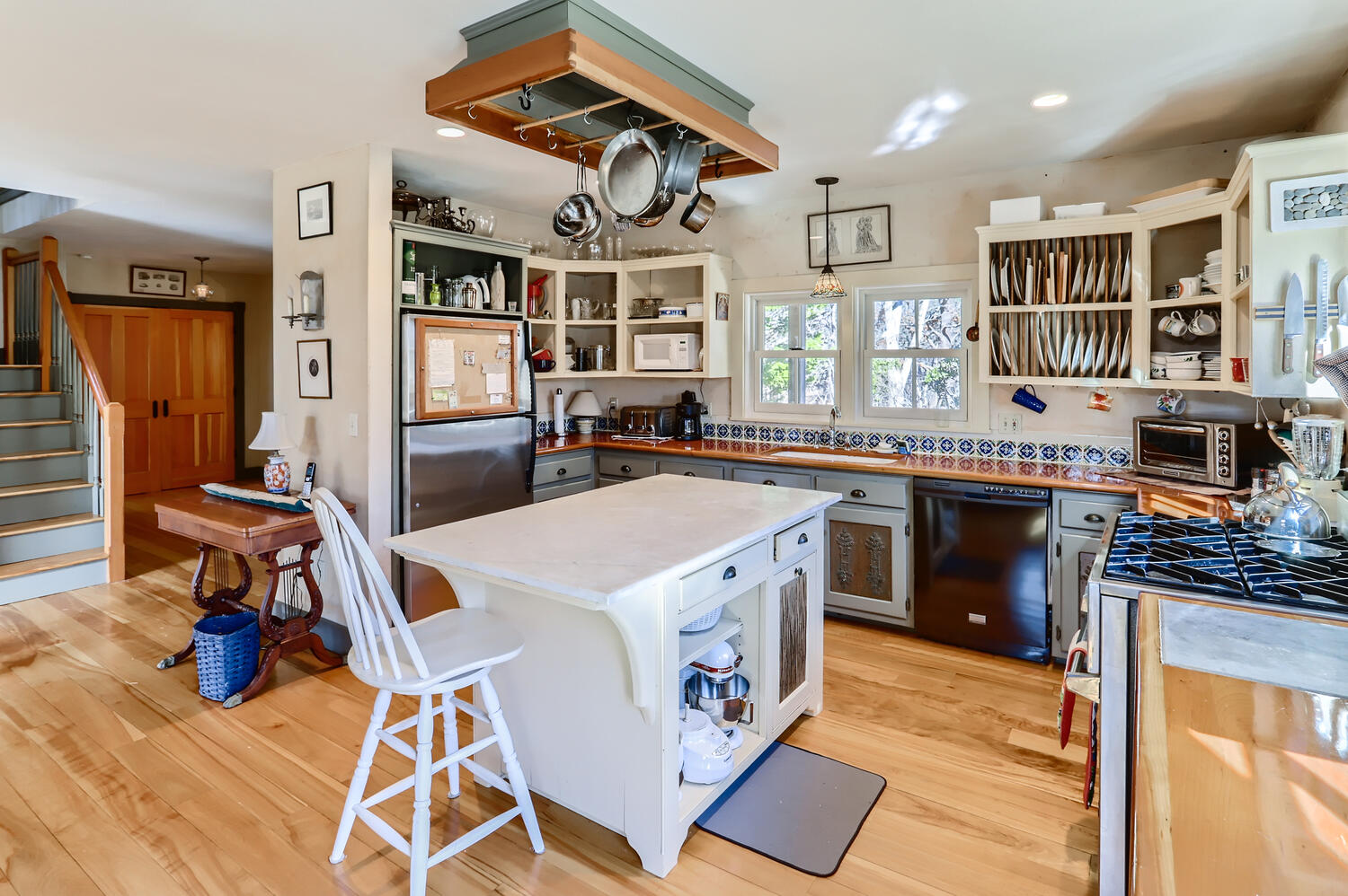 40 Bridle Path Road Vineyard Haven, MA 02568 - Photo 15 of 39 a kitchen that has a lot of cabinets in it and wooden floors