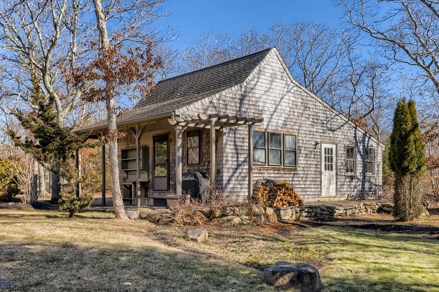 40 Bridle Path Road Vineyard Haven, MA 02568 - Photo 7 of 39 a view of a house with large windows and lawn chairs