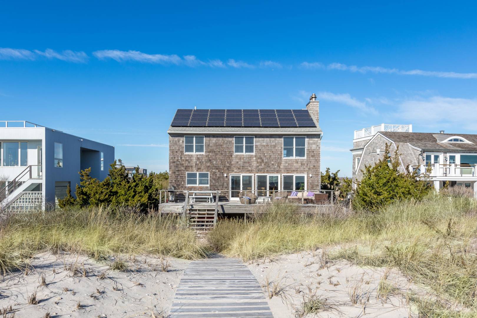 1335 Flying Point Road Water Mill, NY 11976 - Photo 1 of 18 a front view of a house with a yard