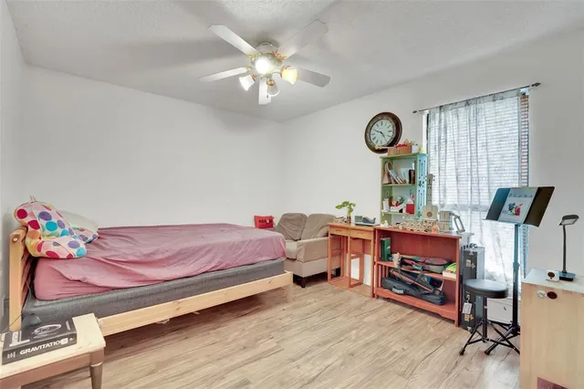 a bedroom with bed and a chandelier