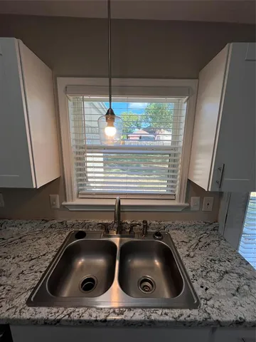 a kitchen with a sink and a stove