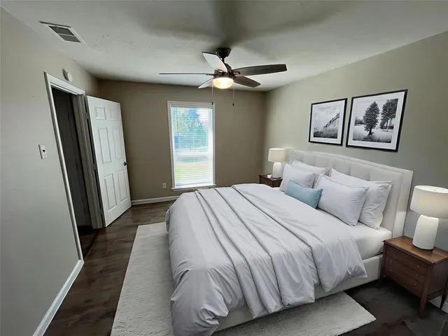 a bedroom with a large bed and a window