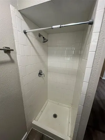 a bathroom with a glass door shower and a sink