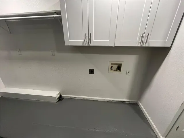 a view of storage and utility room with window