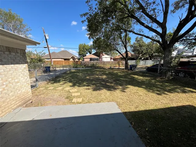 a view of a yard with wooden fence