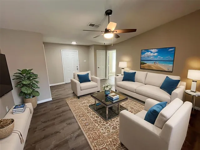 a living room with furniture and a chandelier