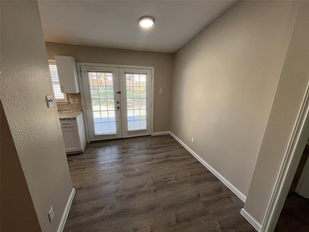 10037 Hymie Circle Dallas, TX 75217 - Photo 7 of 28 an empty room with wooden floor and windows