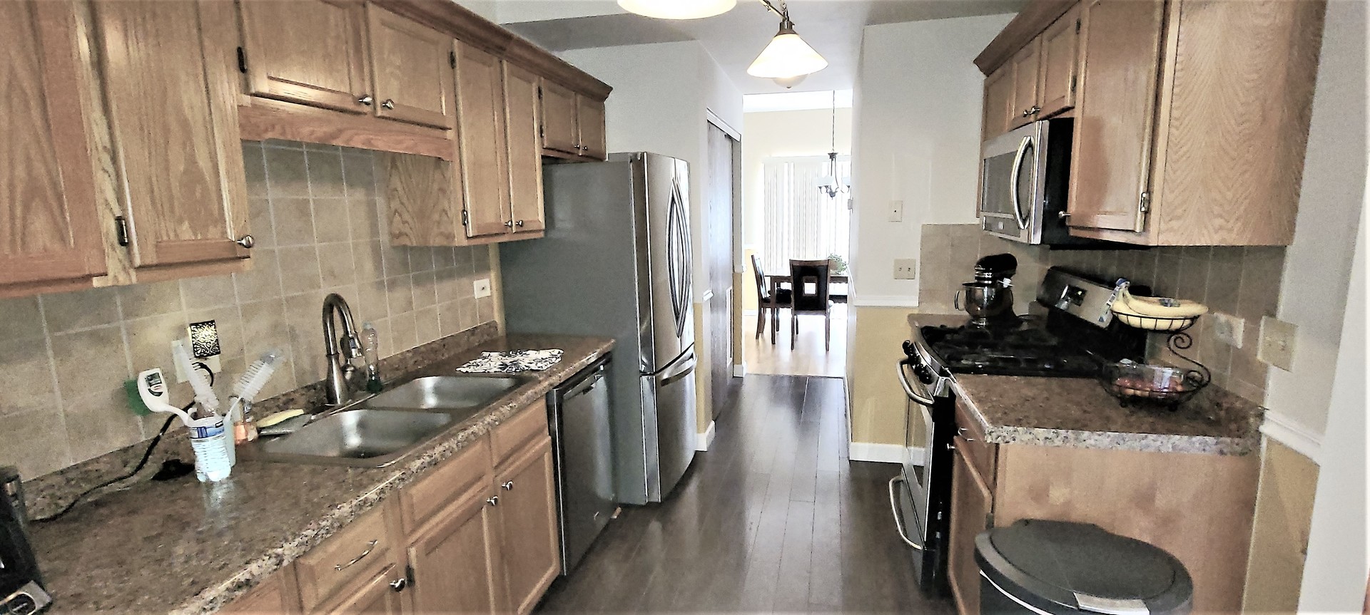 2203 Rossiter Parkway Plainfield, IL 60586 - Photo 11 of 24 a kitchen with a sink stove and refrigerator
