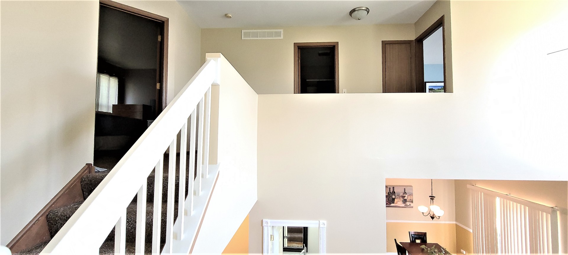 2203 Rossiter Parkway Plainfield, IL 60586 - Photo 14 of 24 a view of a hallway with white walls and stairs