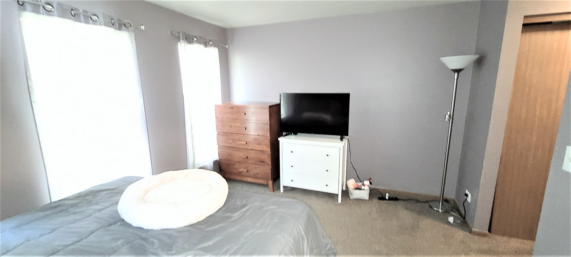 2203 Rossiter Parkway Plainfield, IL 60586 - Photo 18 of 24 a living room with a flat screen tv and white walls