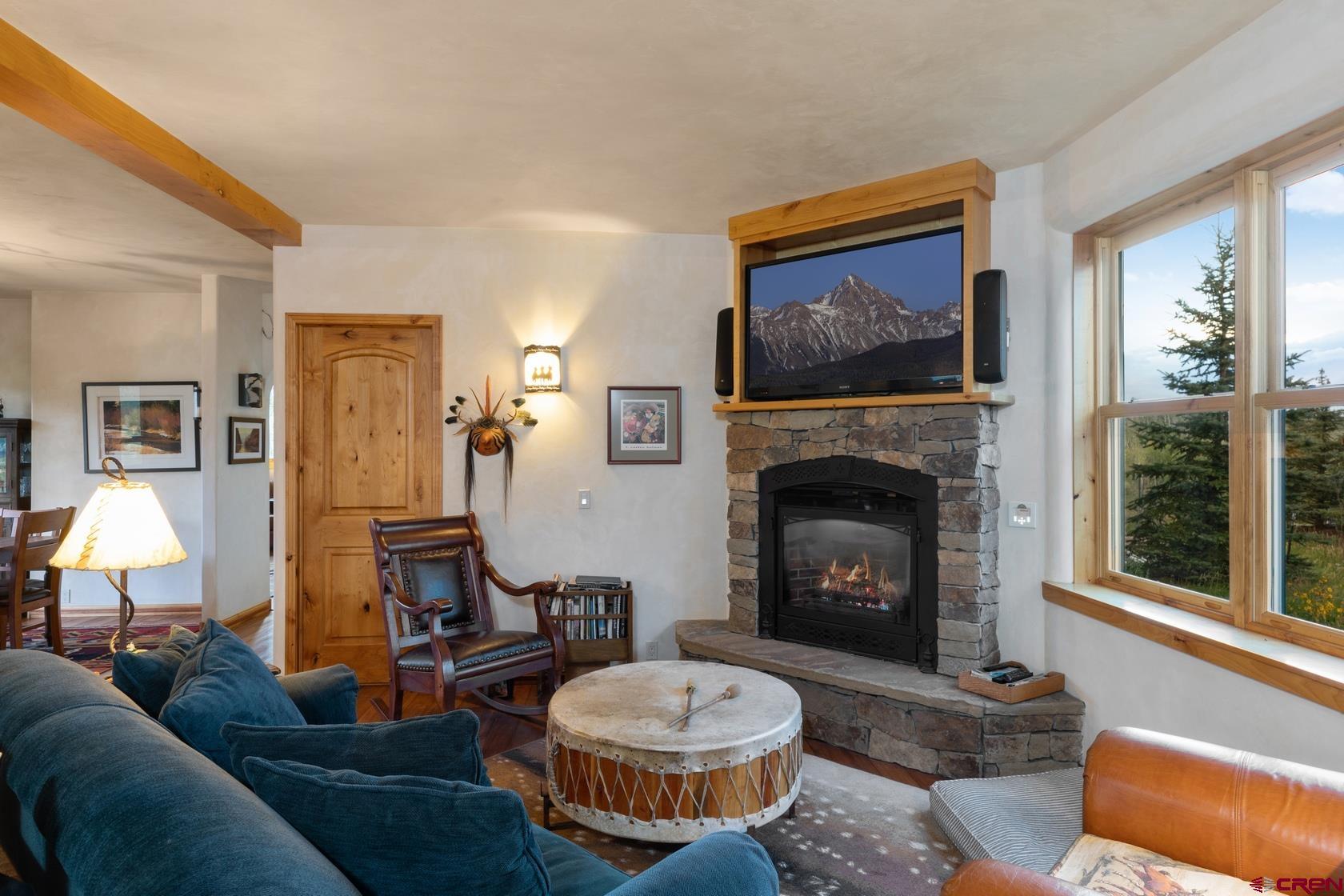 9706 County Road 5 Ridgway, CO 81432 - Photo 13 of 33 a living room with furniture a window and a fireplace