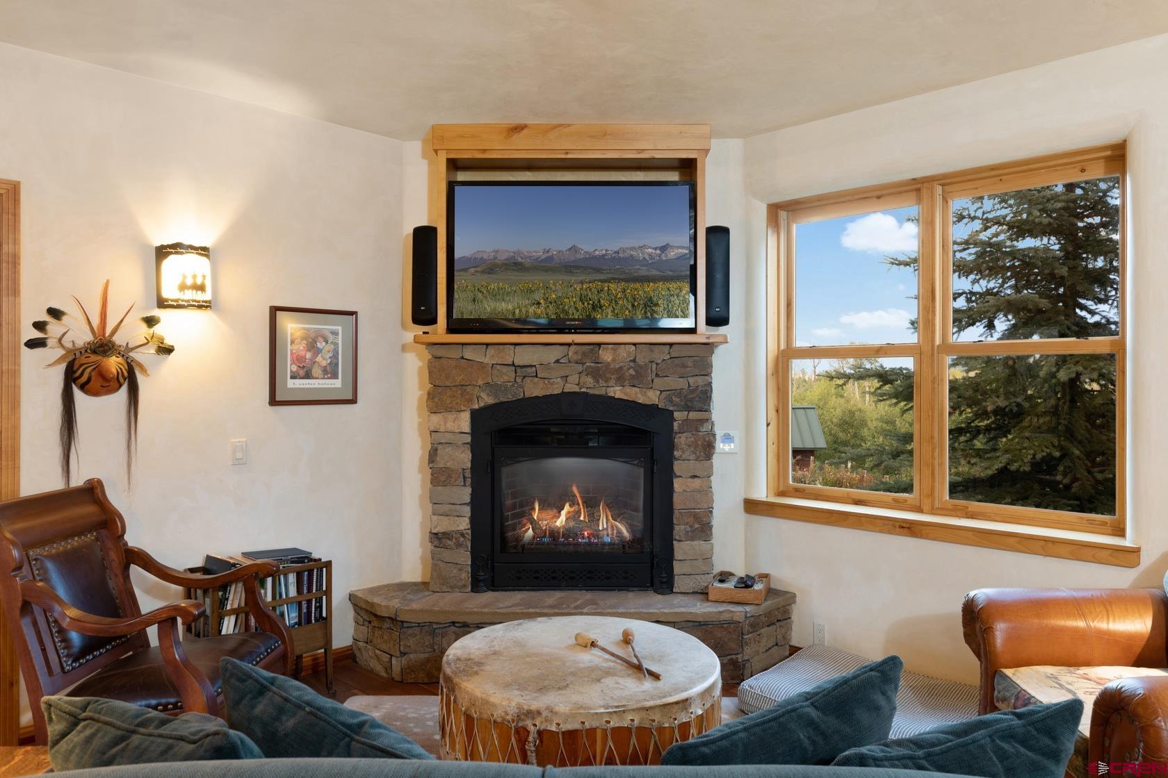 9706 County Road 5 Ridgway, CO 81432 - Photo 14 of 33 a living room with furniture a window and a fireplace
