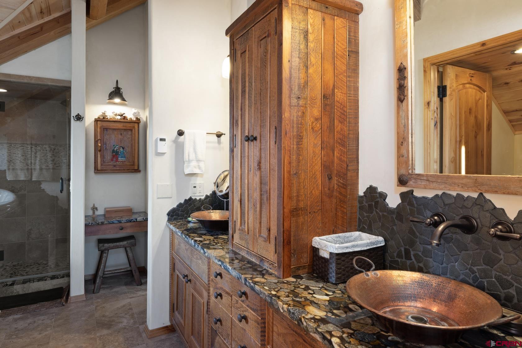 9706 County Road 5 Ridgway, CO 81432 - Photo 20 of 33 a bathroom with double vanity and a mirror