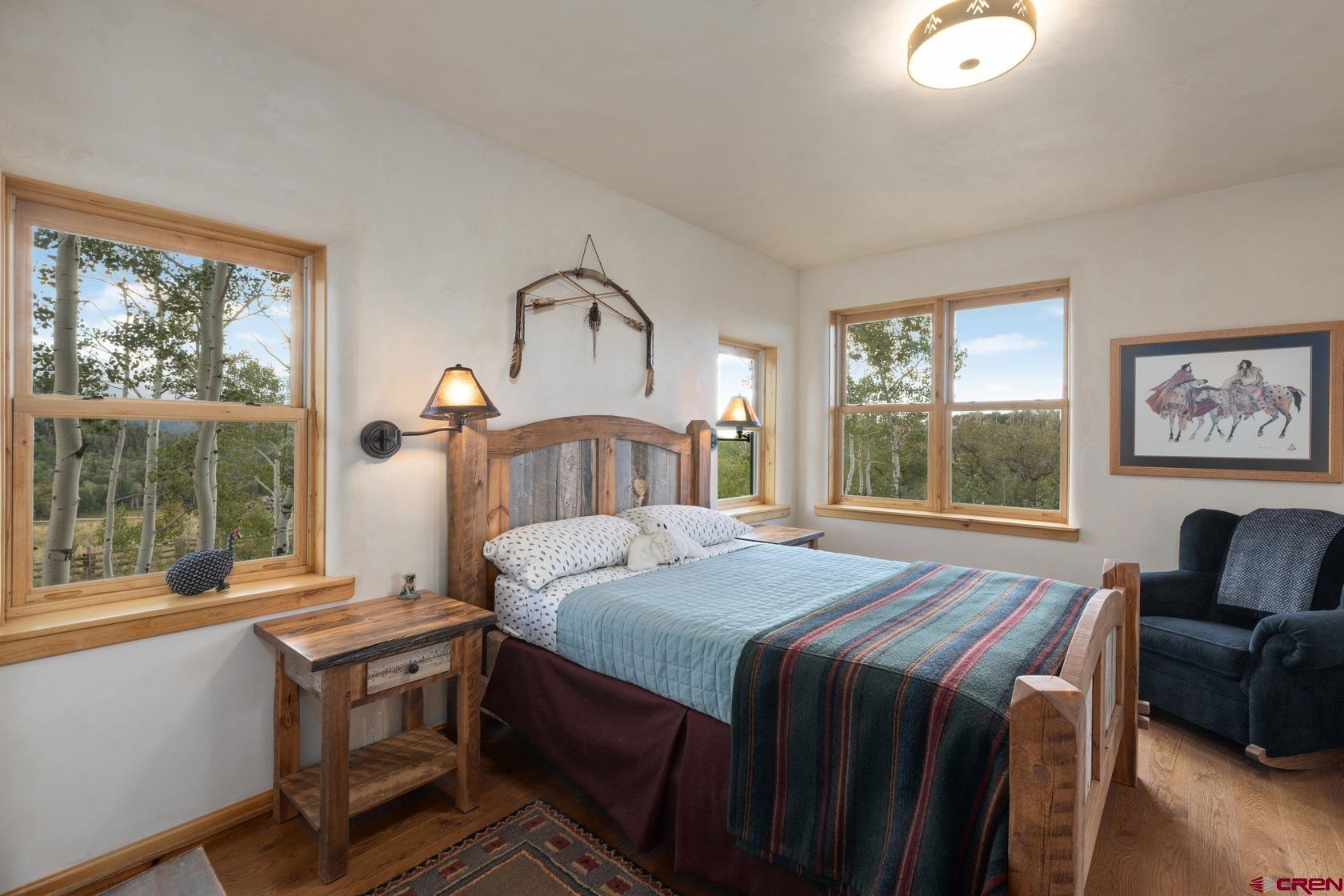 9706 County Road 5 Ridgway, CO 81432 - Photo 21 of 33 a bedroom with a bed and a large window