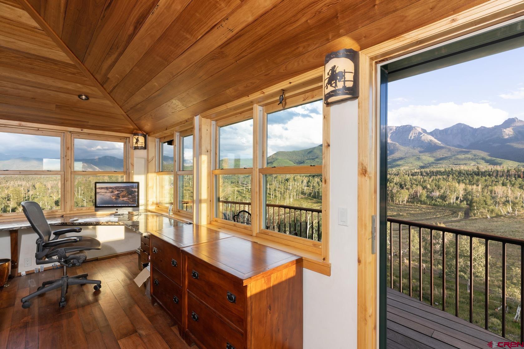 9706 County Road 5 Ridgway, CO 81432 - Photo 22 of 33 a view of a living room with furniture and floor to ceiling windows