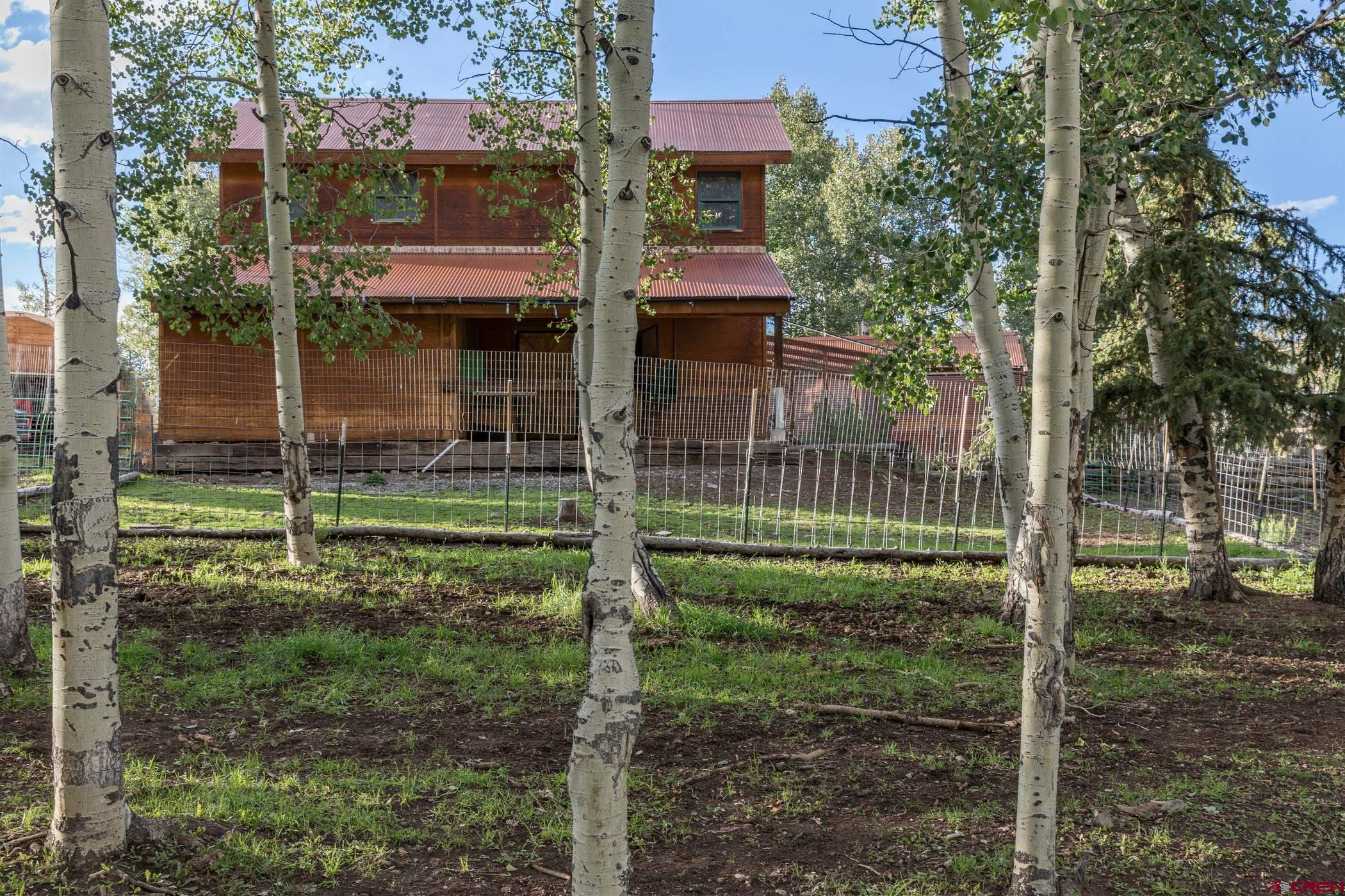 9706 County Road 5 Ridgway, CO 81432 - Photo 31 of 33 a view of a house with a backyard