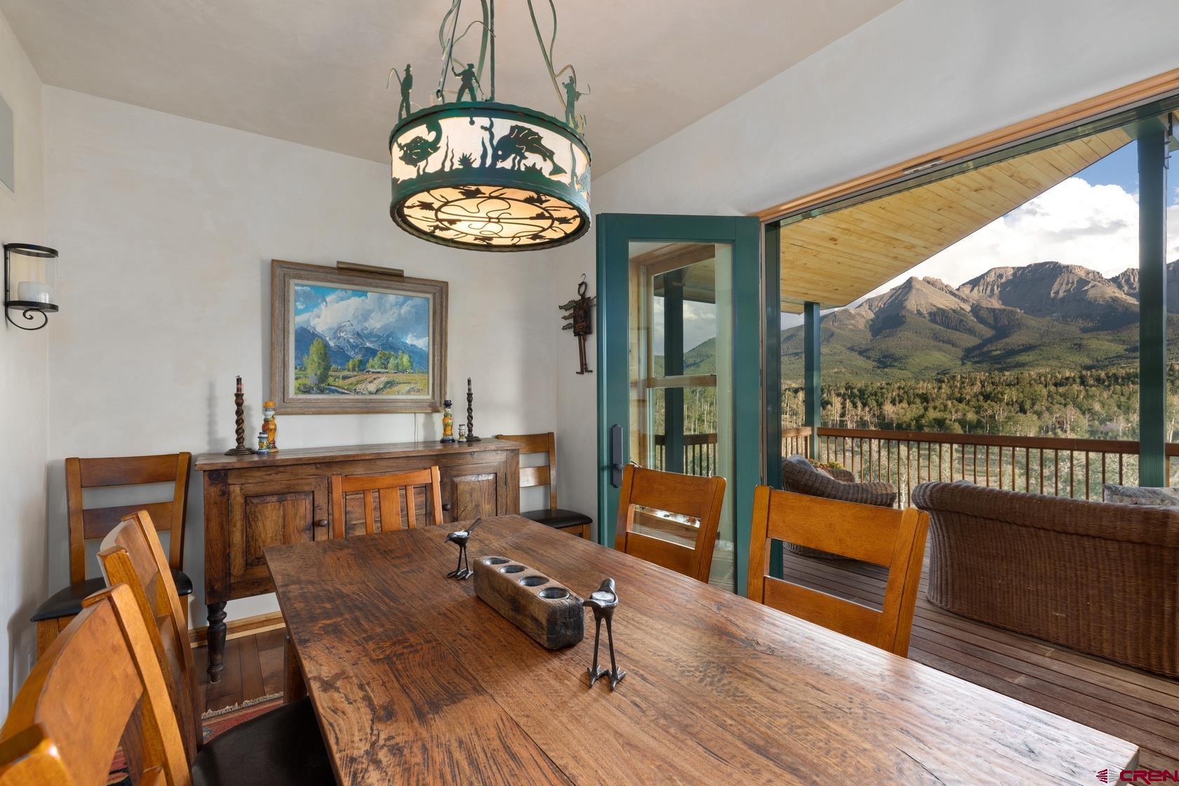 9706 County Road 5 Ridgway, CO 81432 - Photo 9 of 33 a view of a dining room with furniture wooden floor and a chandelier