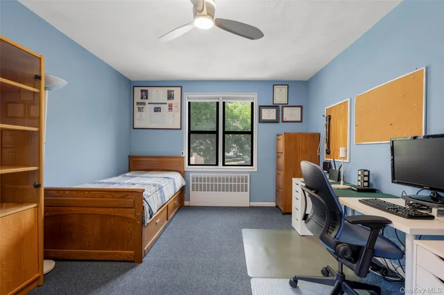 a bedroom with a bed and a desk