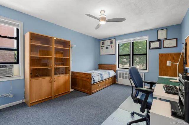 a bedroom with furniture and a window