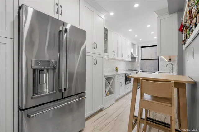 a kitchen with a refrigerator and a sink