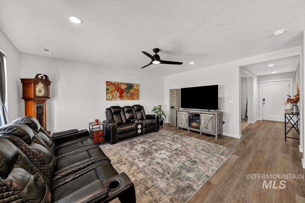 8575 South Foraker Way Kuna, ID 83634 - Photo 6 of 43 Recessed lighting, LVP flooring, ceiling fan, and white walls