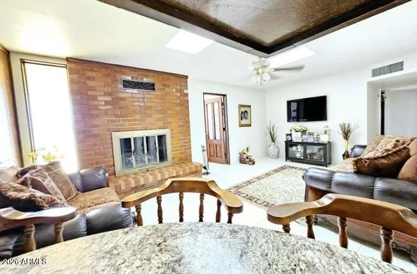 a living room with furniture flat screen tv and a fireplace
