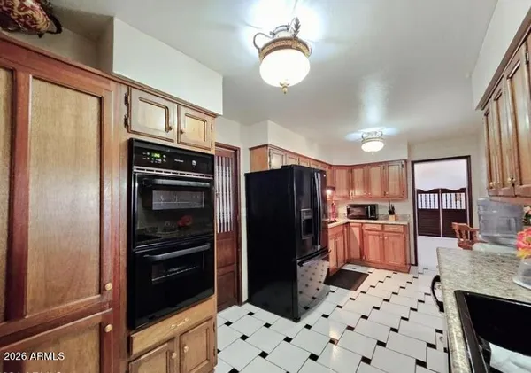 a kitchen with stainless steel appliances a refrigerator and a stove top oven