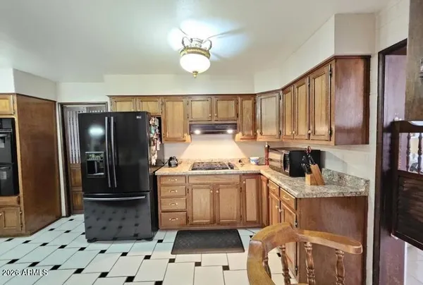 a kitchen with stainless steel appliances a stove a refrigerator and cabinets