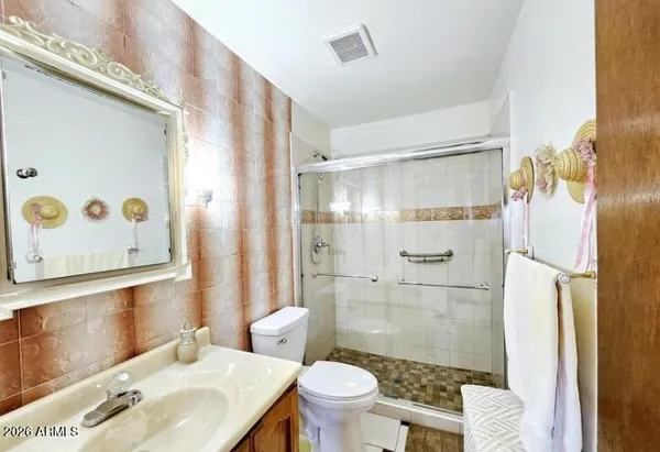 a bathroom with a shower and a sink