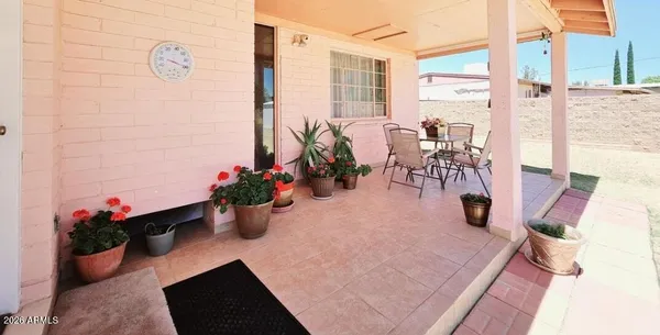 a view of a white house with a yard