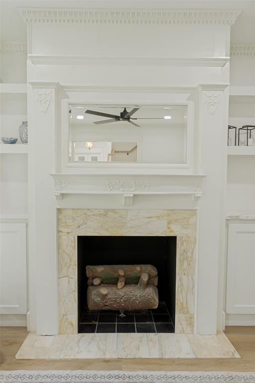 4316 Springbranch Drive Benbrook, TX 76116 - Photo 8 of 39 Ornate fireplace with decorative crown molding, a reflective mirror, integrated shelving, and a tiled hearth