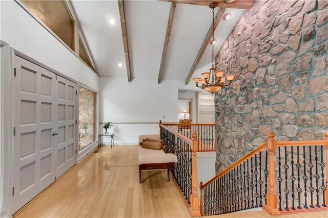 a living room with furniture a fireplace and a large window