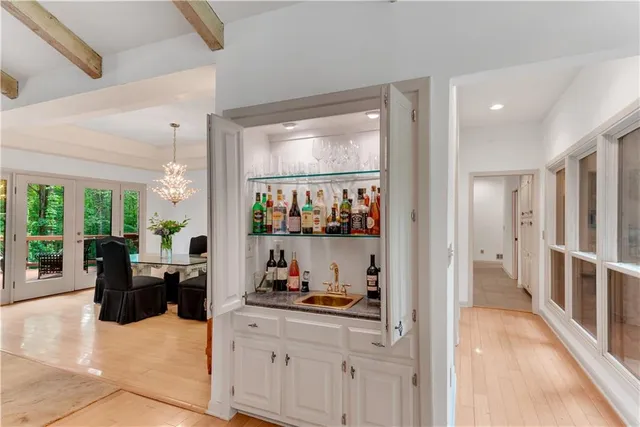 a kitchen with granite countertop a table chairs microwave and cabinets