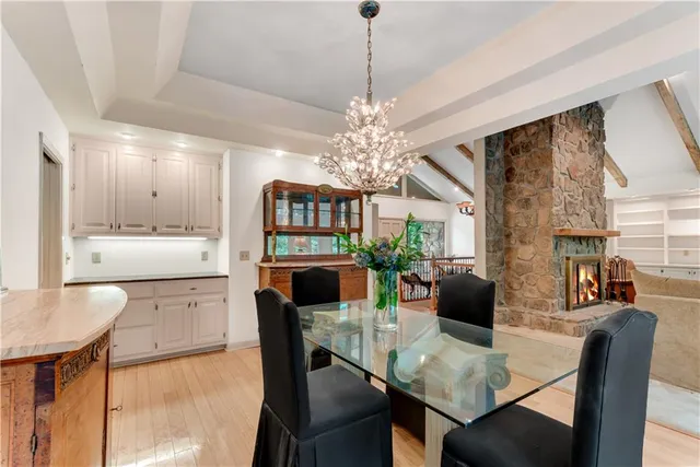 a living room with furniture a fireplace and a table