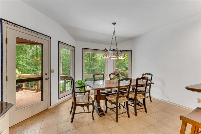 a living room with furniture and a table with wooden floor