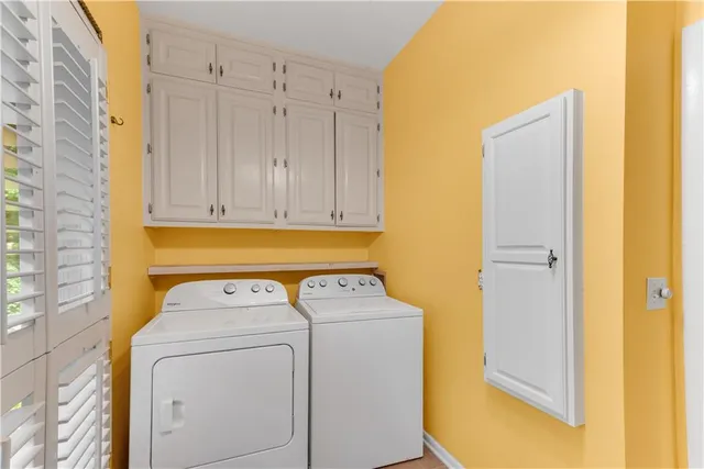 a view of a bedroom with a bed and wooden floor