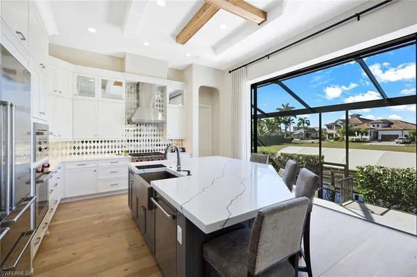 a kitchen with a stove a refrigerator and a dining table